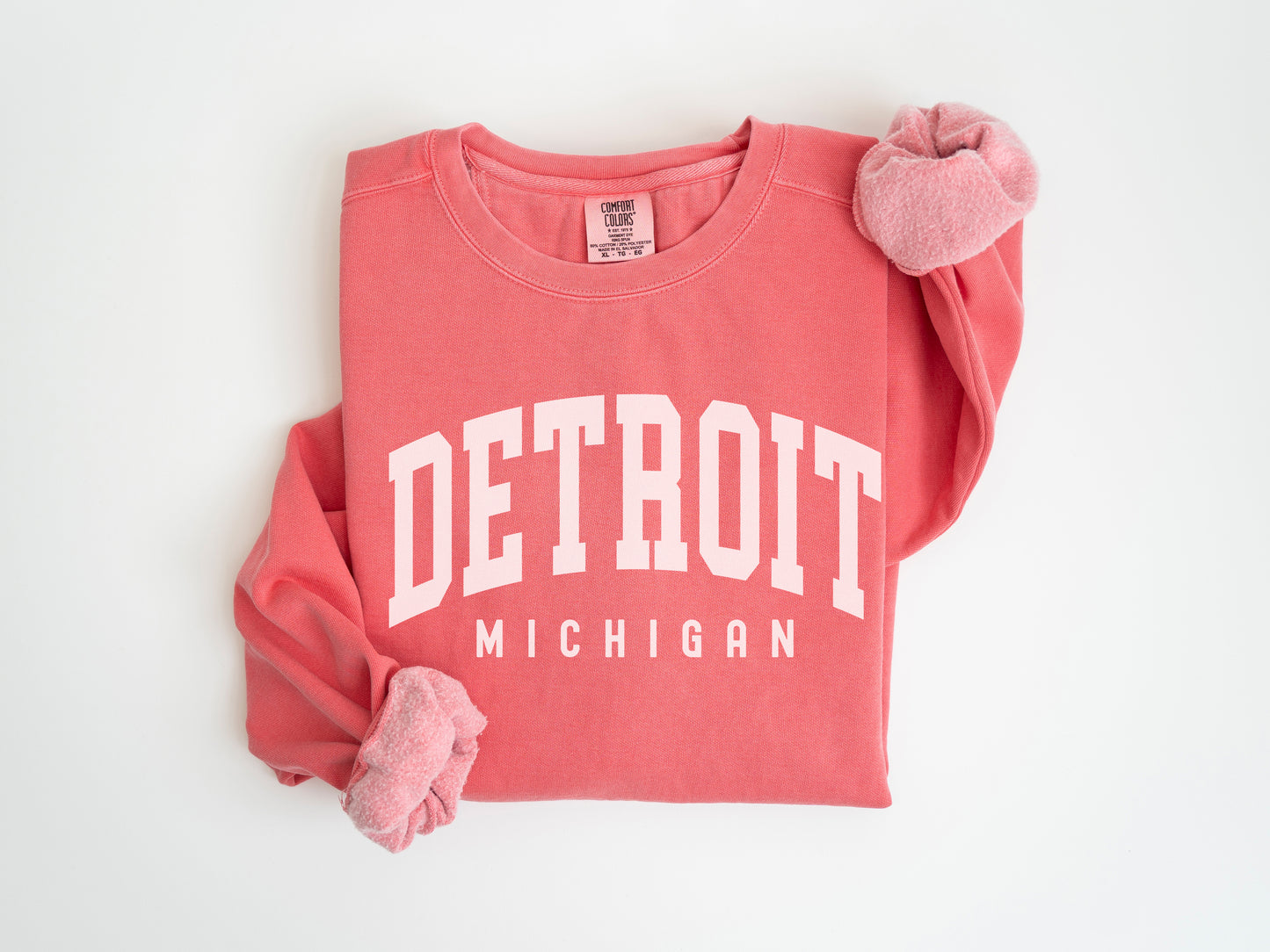 a red detroit sweatshirt with a pink pom pom