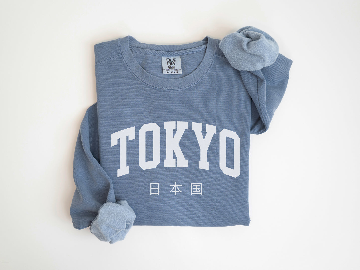 a blue sweatshirt with the word tokyo printed on it