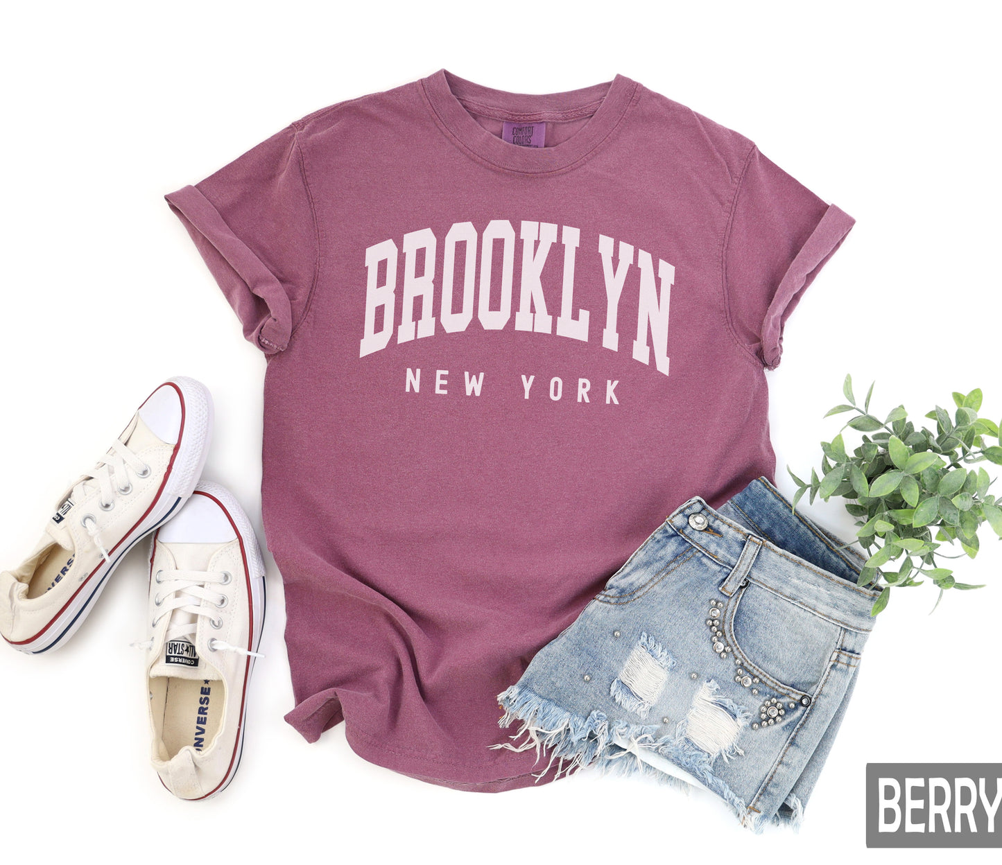 a t - shirt that says brooklyn, next to a pair of shorts