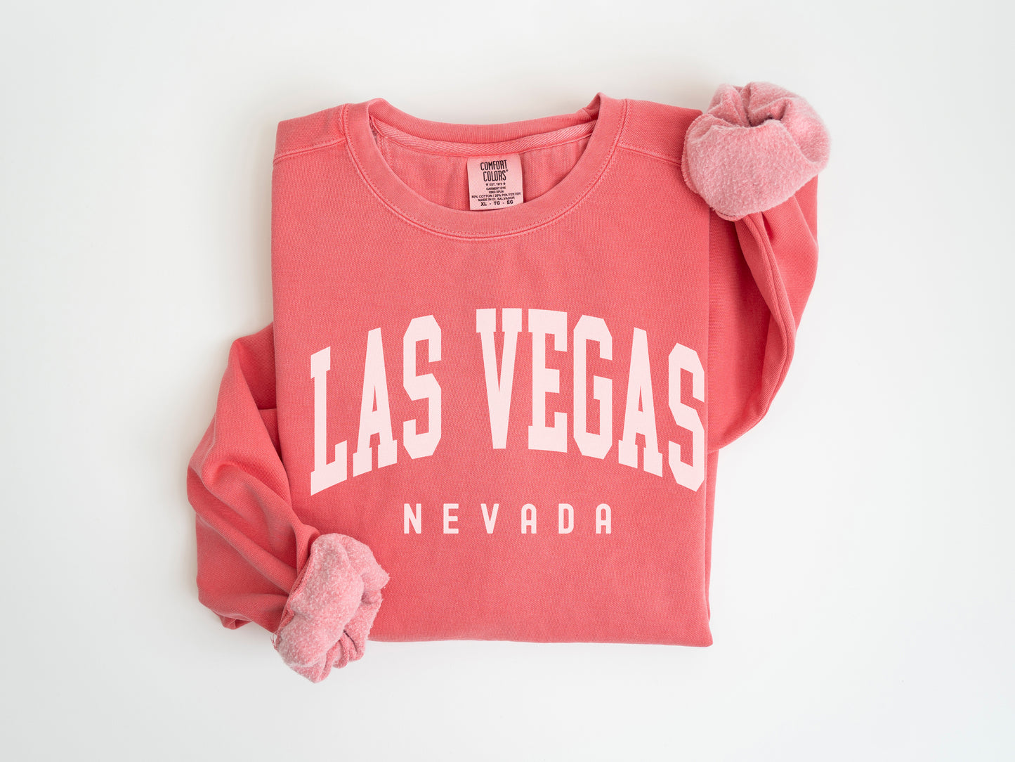 a red shirt with a white las vegas logo on it