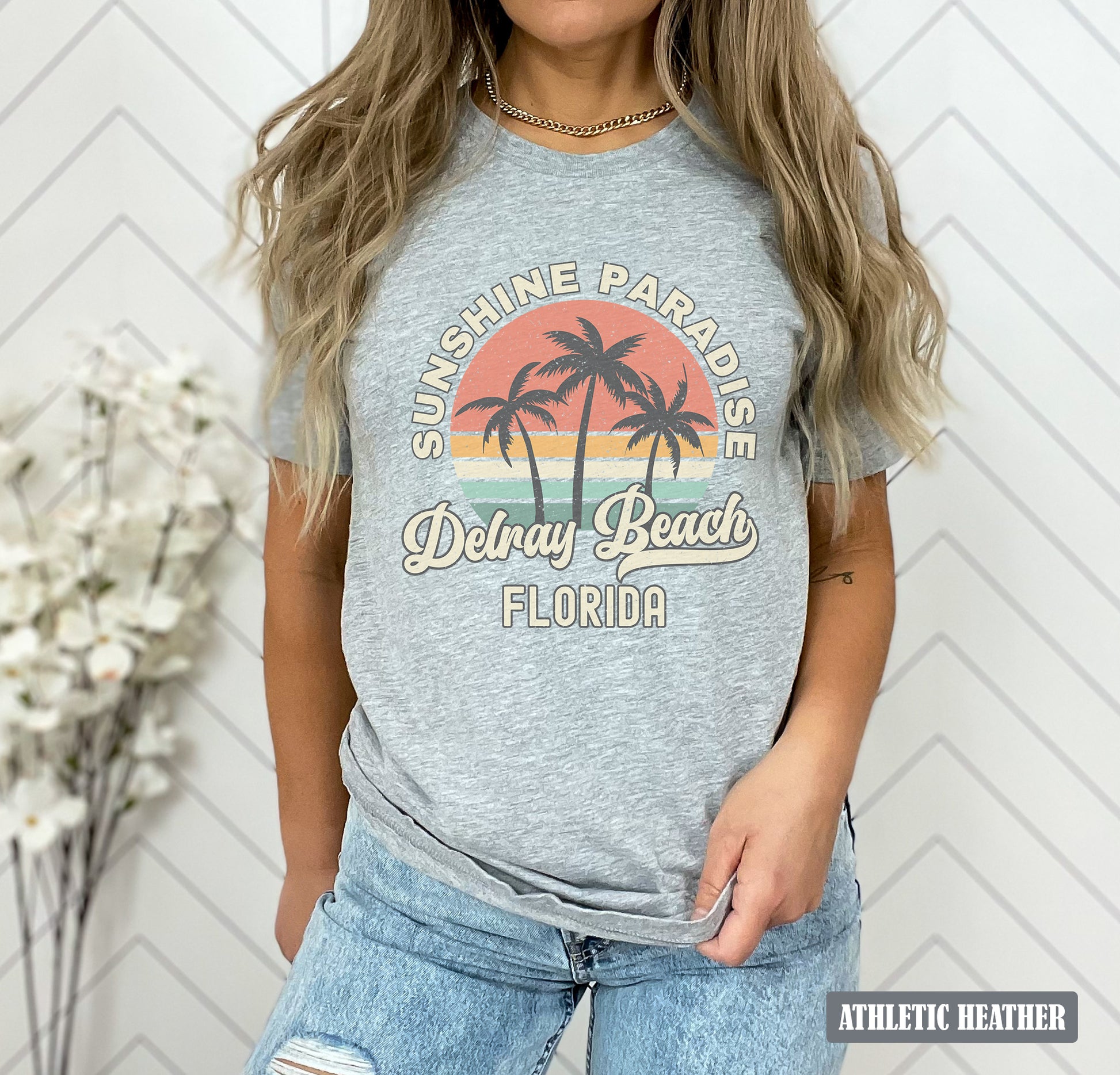 a woman wearing a grey shirt with palm trees on it