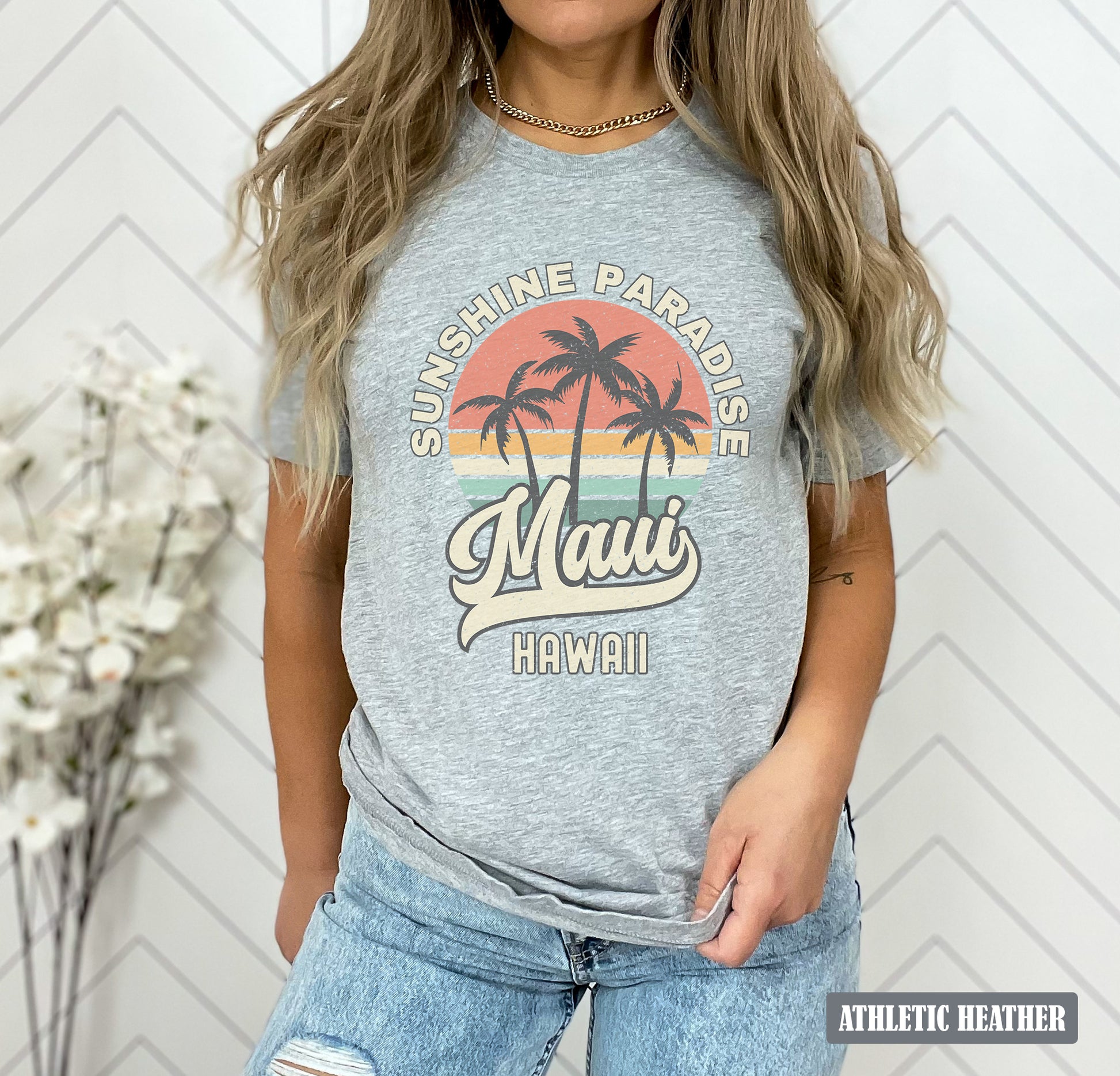 a woman wearing a gray shirt with a palm tree on it