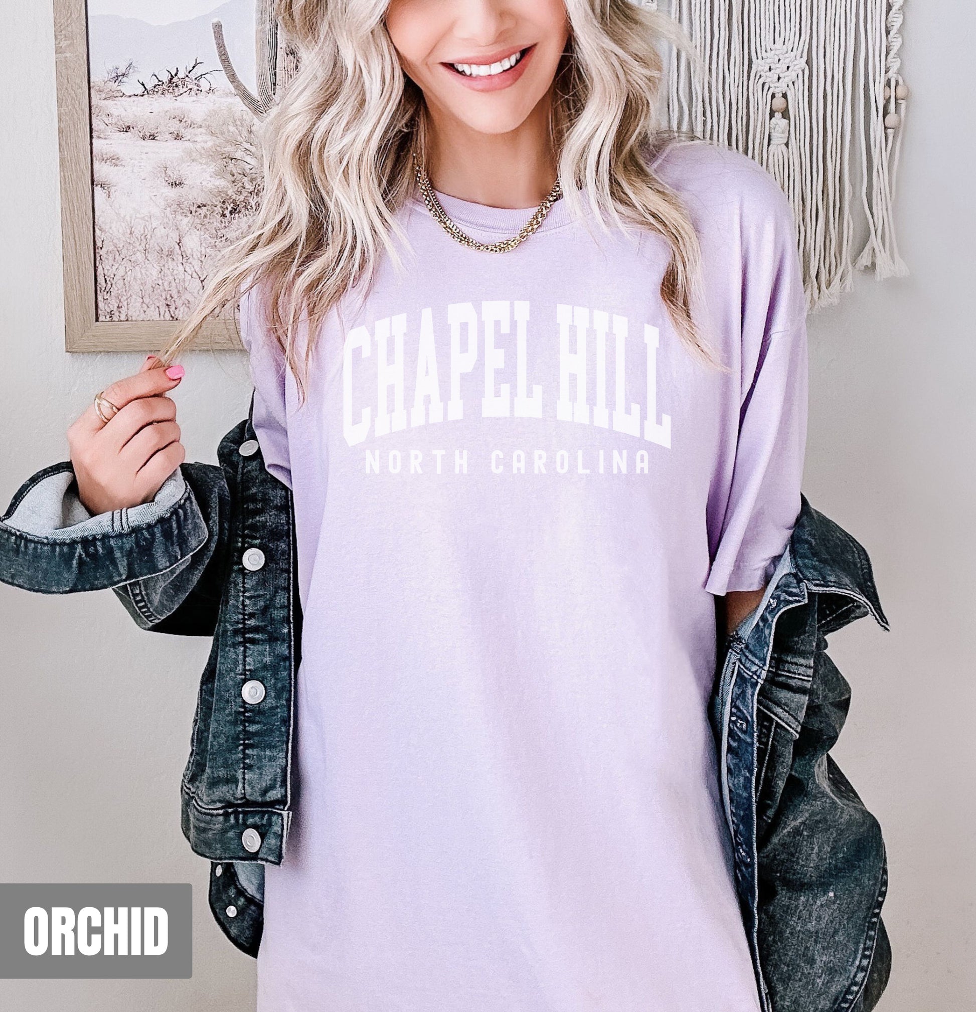 a woman wearing a purple chapel hill t - shirt