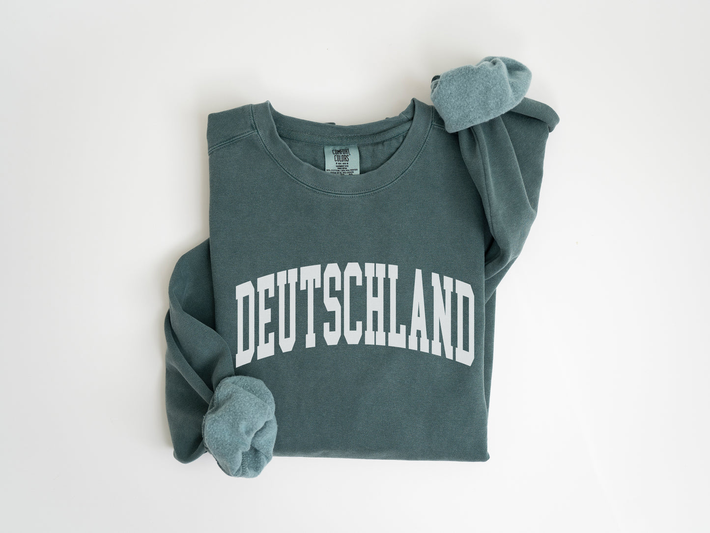 a green sweatshirt with the word deutschland printed on it