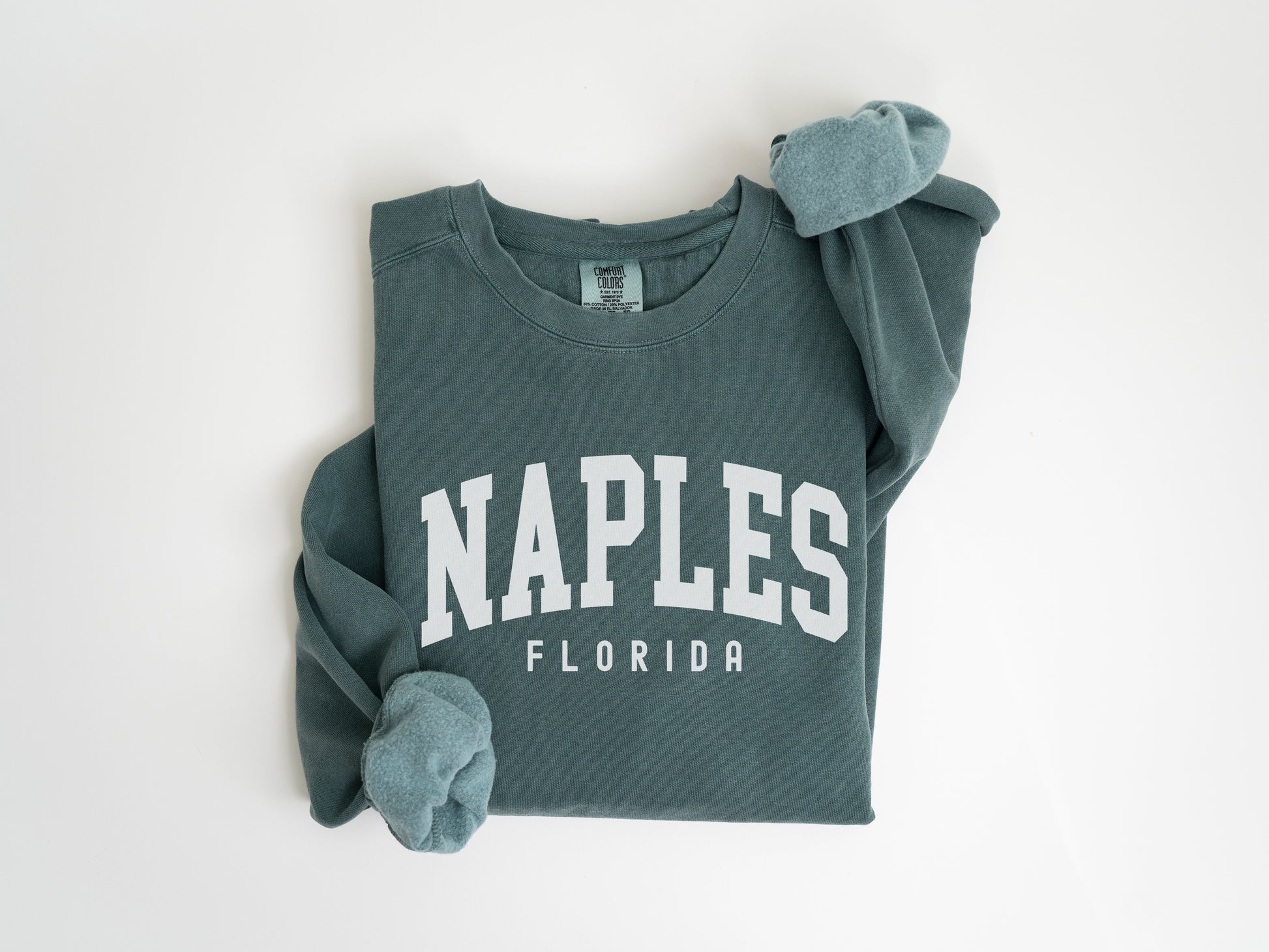 a green shirt with the word naples on it