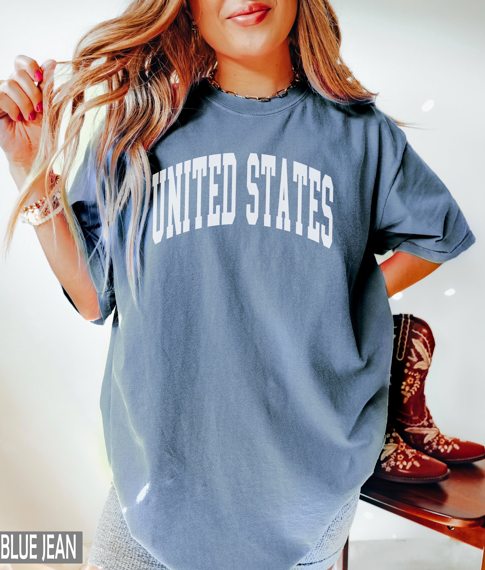 a woman posing for a picture wearing a shirt that says united states