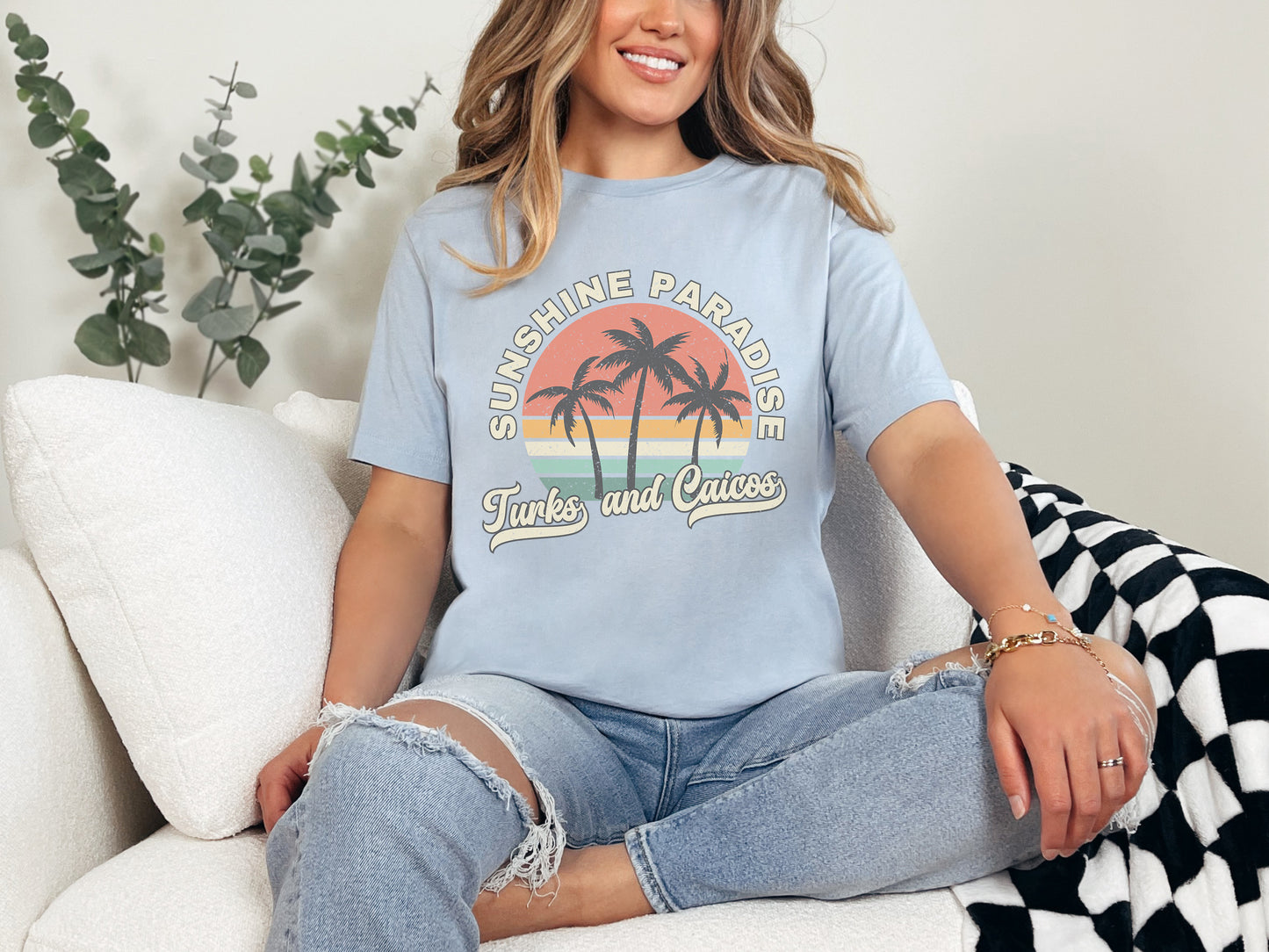 a woman sitting on a couch wearing a blue shirt