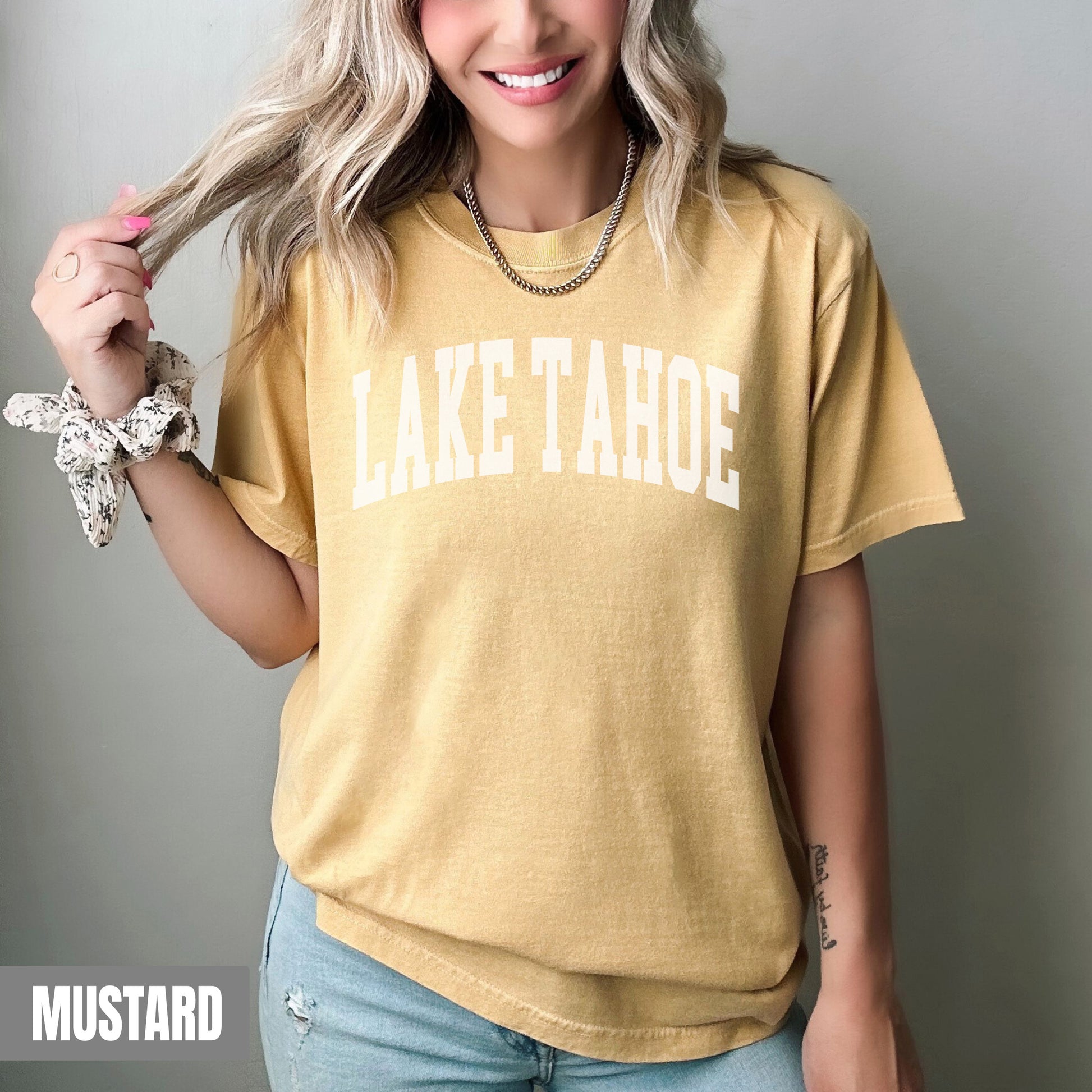 a woman with blonde hair wearing a lake tahoe t - shirt