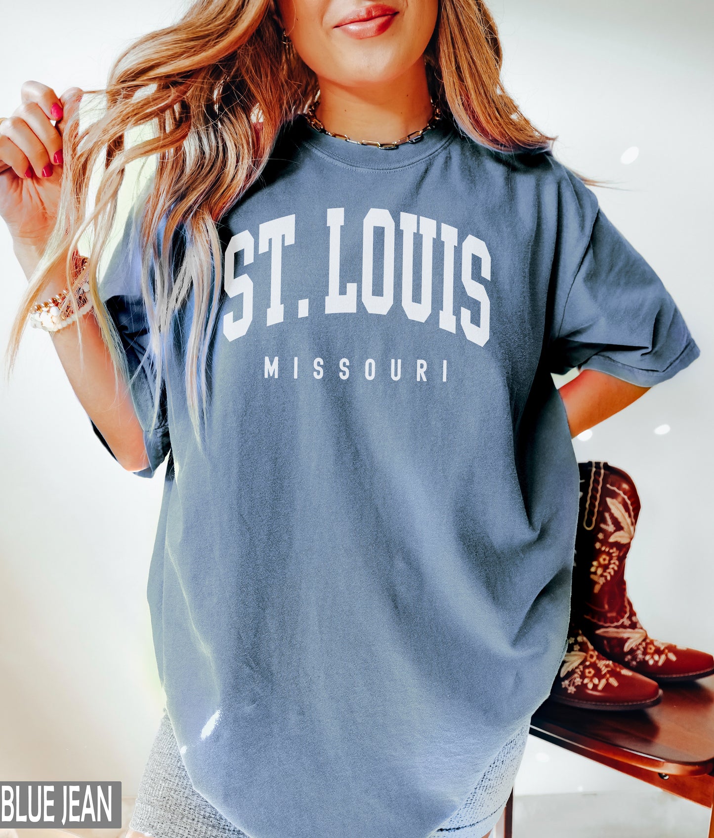 a woman in a st louis shirt posing for a picture