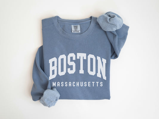 a blue boston sweatshirt with a hat on top of it