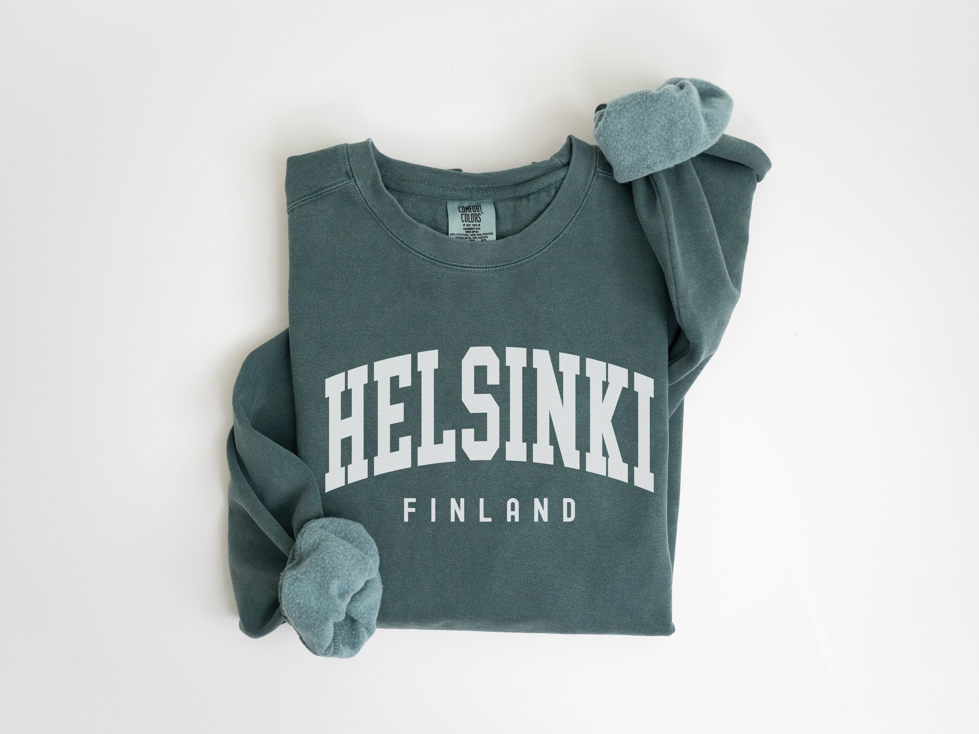 a green sweatshirt with the words helsinki on it