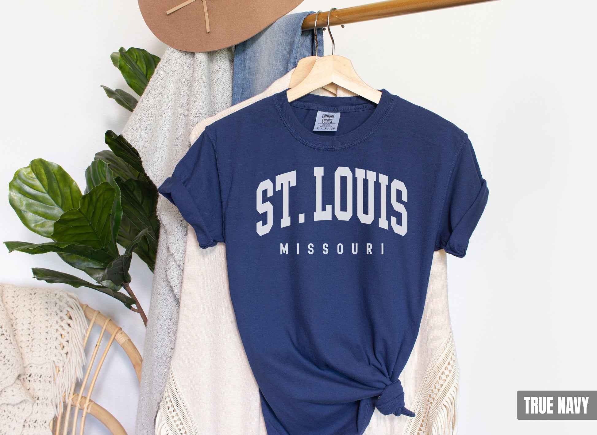 a t - shirt that says st louis missouri hangs on a rack