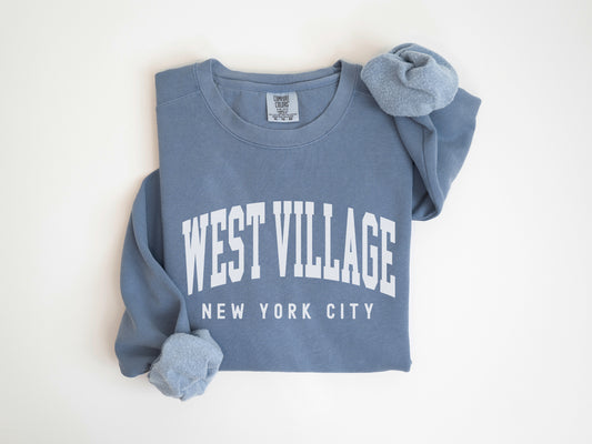 a blue sweatshirt with the words west village on it