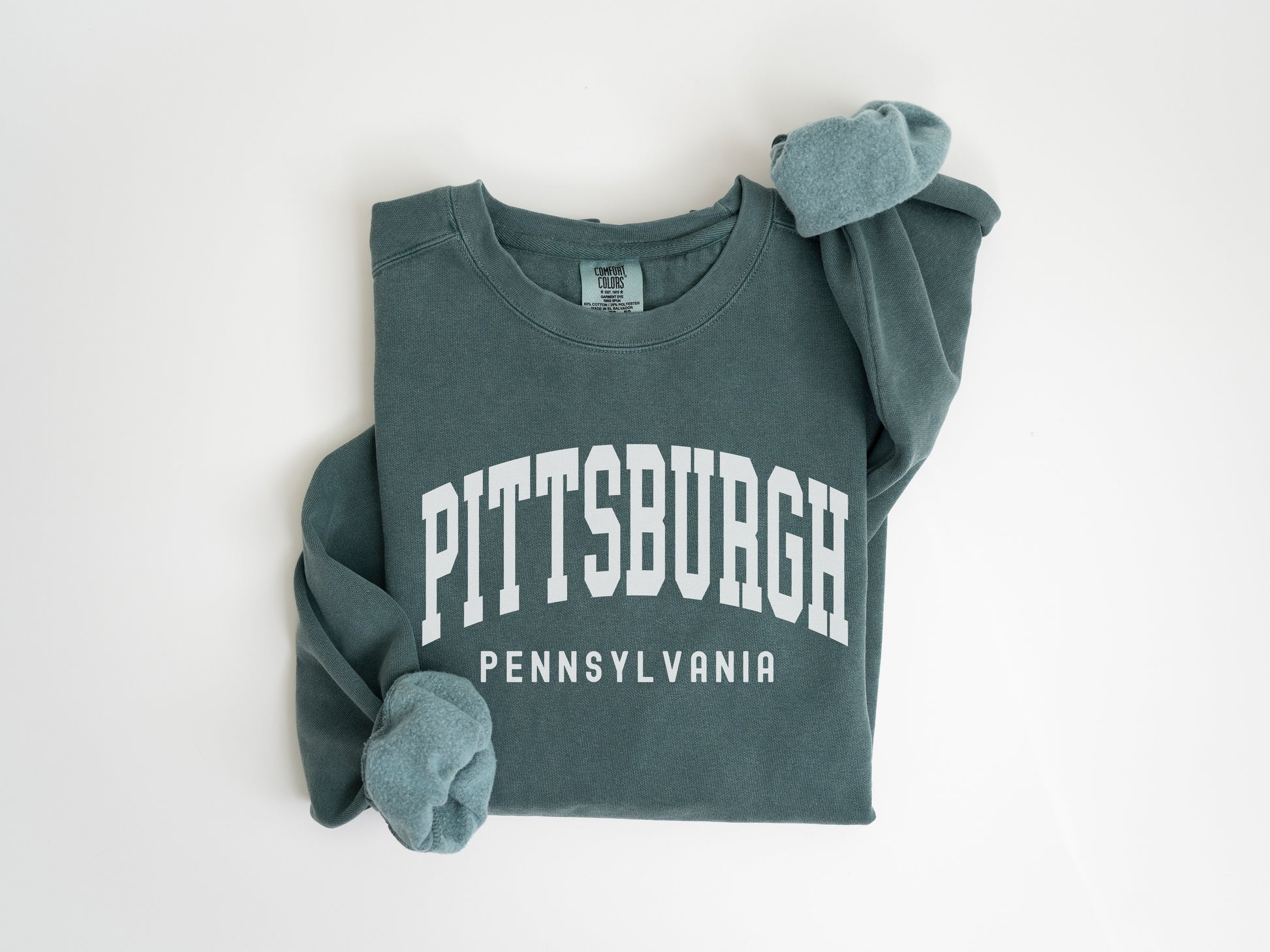 a green sweatshirt with the words pittsburgh on it