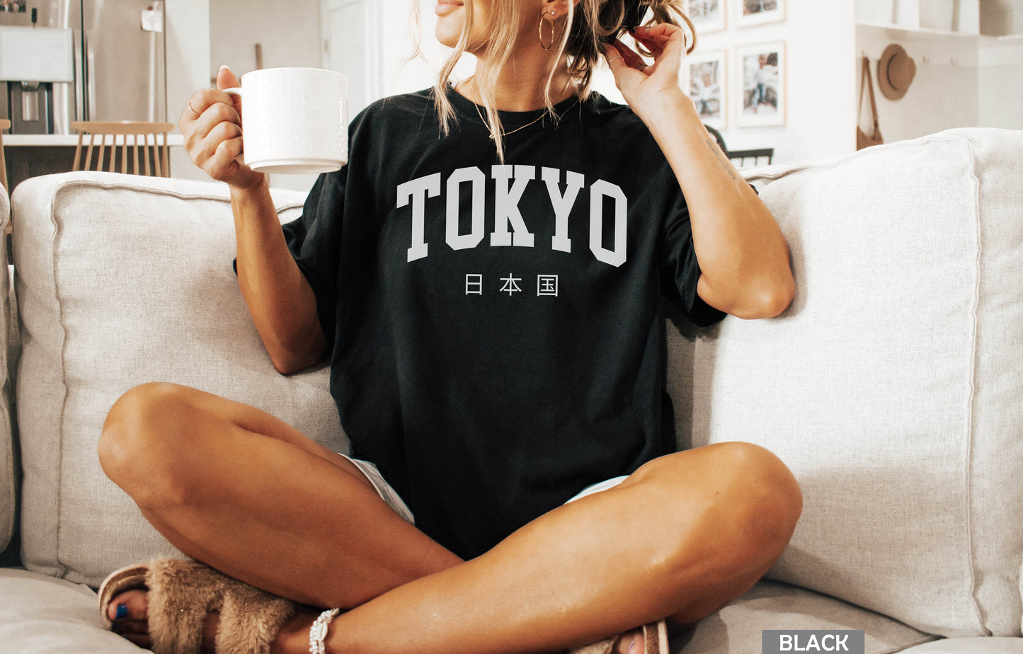 a woman sitting on a couch holding a cup of coffee